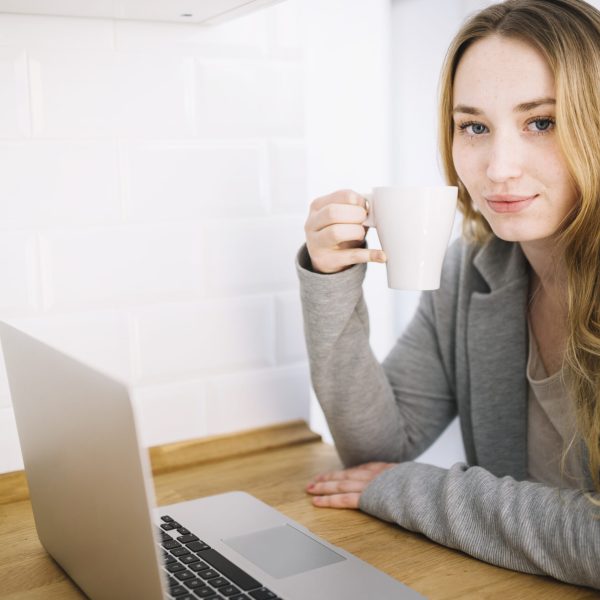woman-with-mug-laptop-kitchen